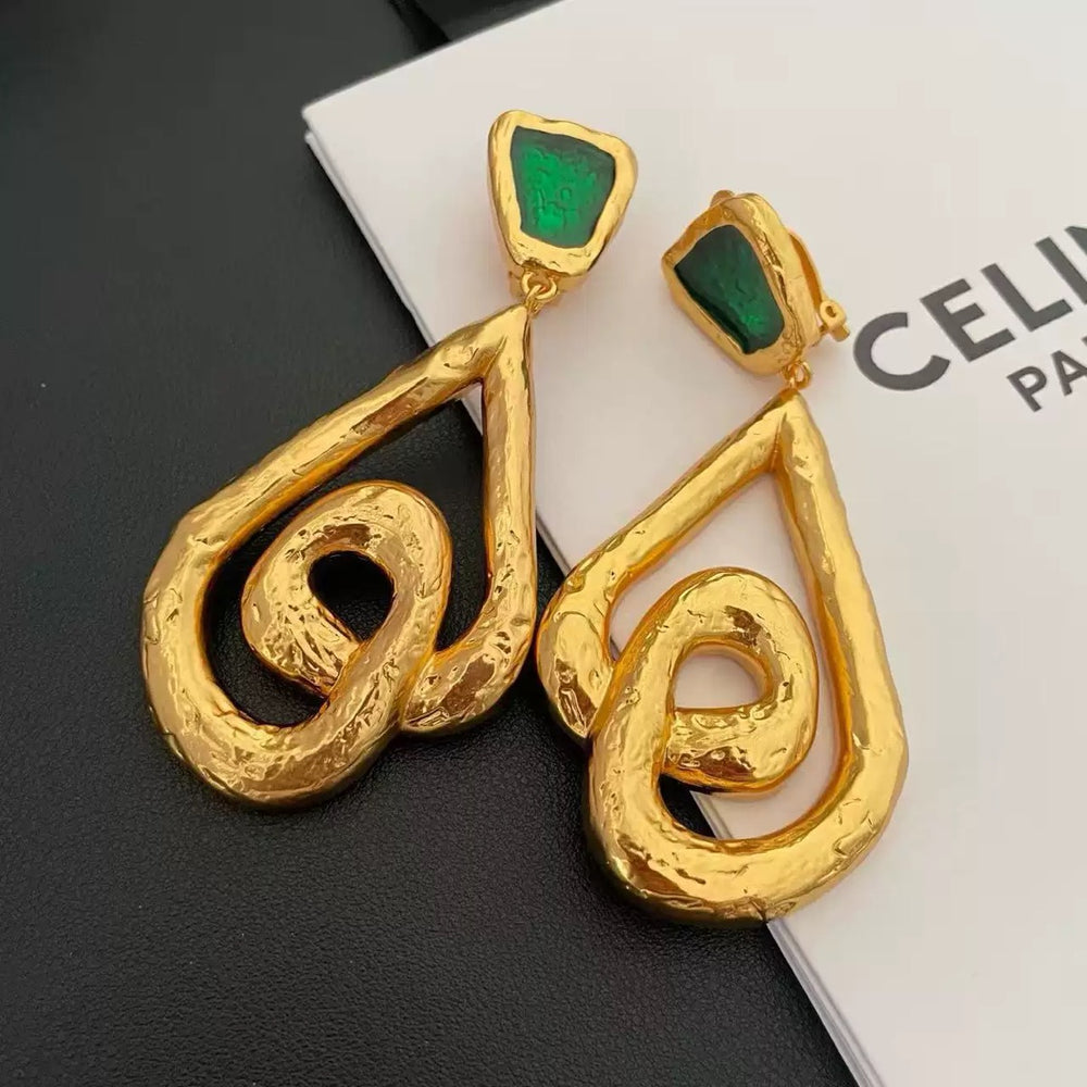 Gold-tone clip-on statement earrings with green stone-style tops and sculptural dangling drops