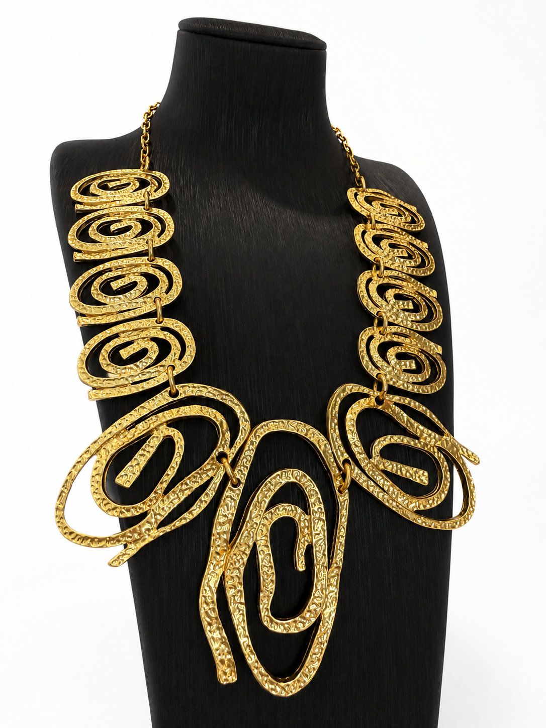 Gold-tone hammered swirl statement necklace angled detail view