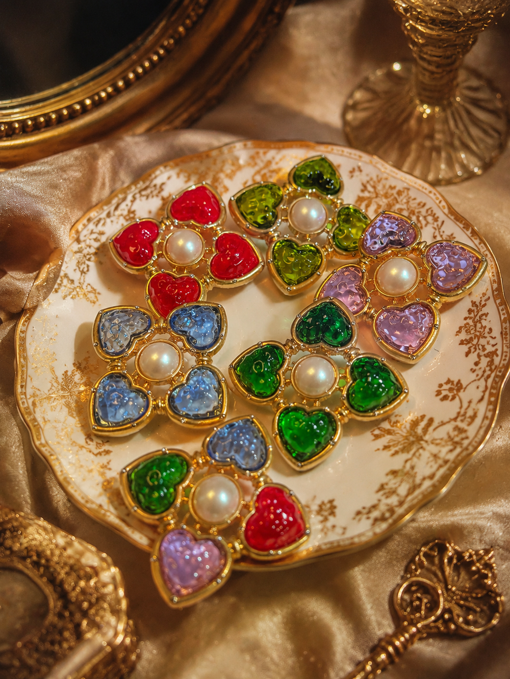Gold-tone heart glass-style convertible brooch pendants in assorted colors on vintage plate
