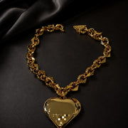 Gold-tone heart pendant chain necklace laid flat