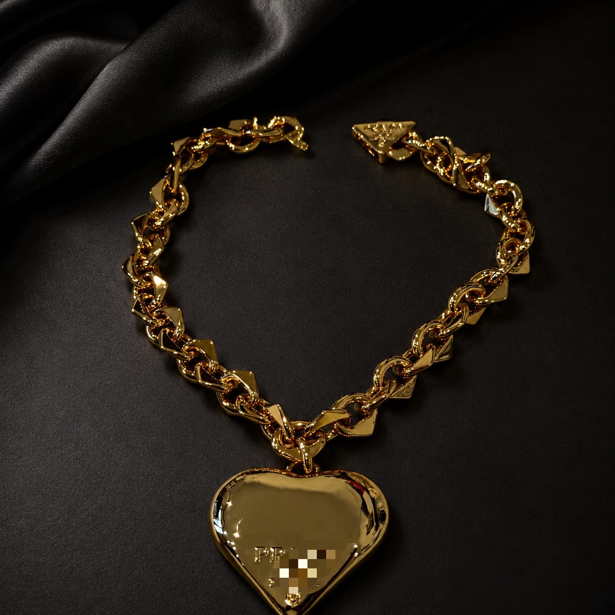 Gold-tone heart pendant chain necklace laid flat