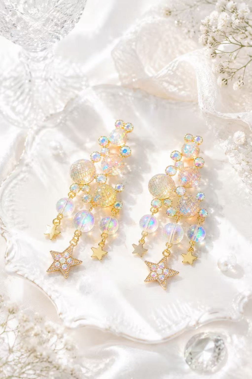 Gold-tone iridescent crystal-style star tassel drop stud earrings front view