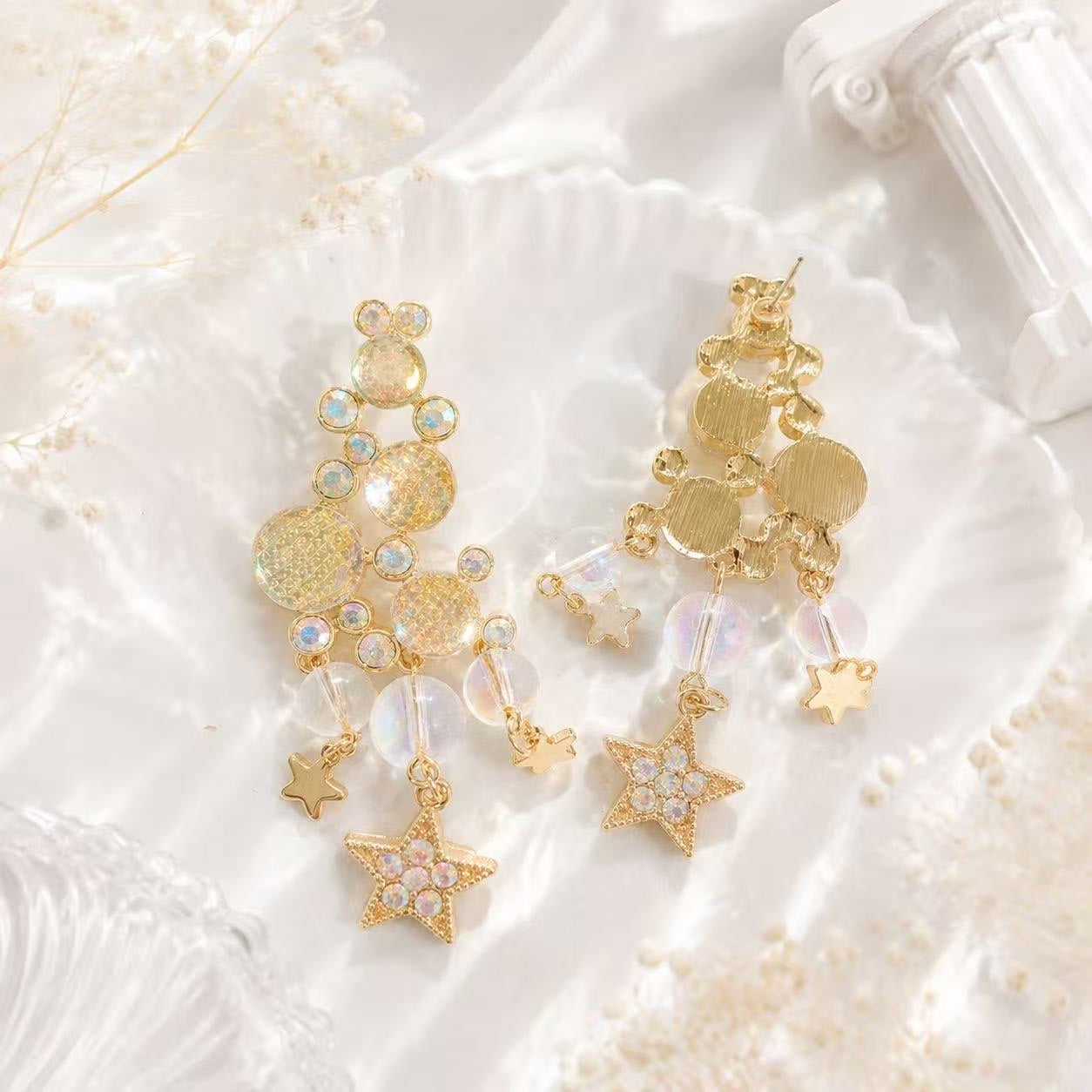 Gold-tone iridescent star tassel drop stud earrings front and back view