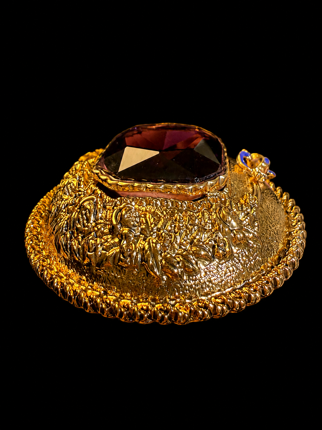 Gold-tone large glass crystal-style statement brooch side view showing raised faceted centerpiece