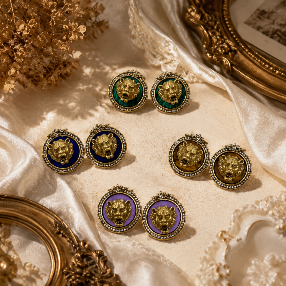 Gold-tone lion head crystal-style stud earrings in blue, khaki, purple, and green