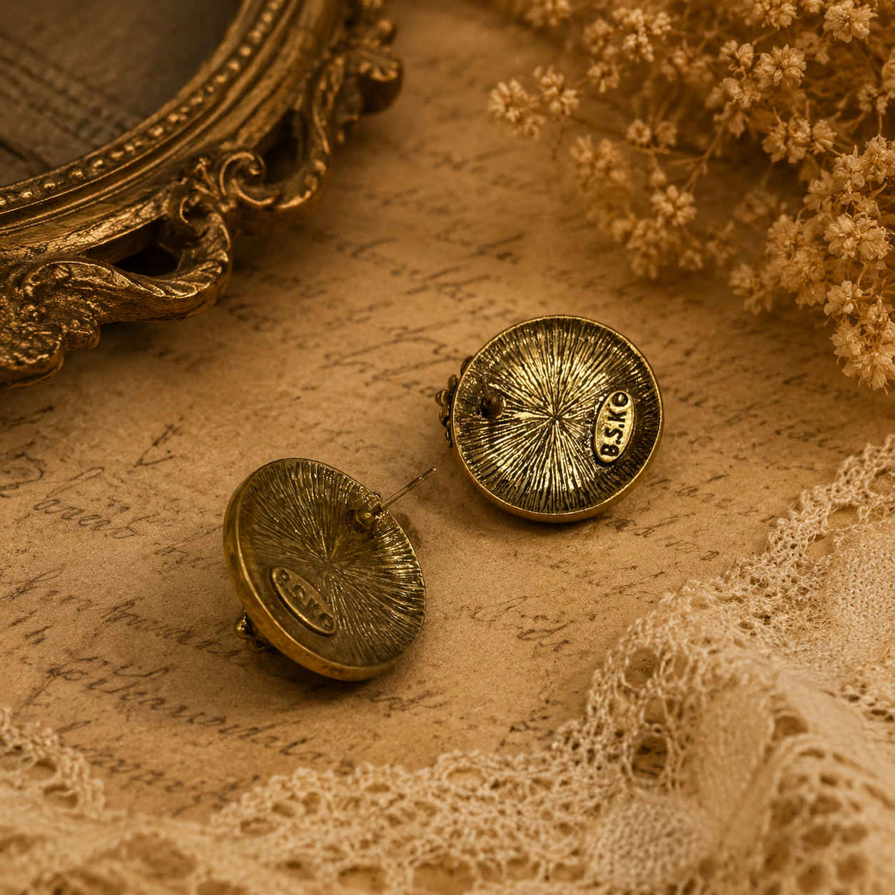 Back view of gold-tone lion head stud earrings showing straight posts