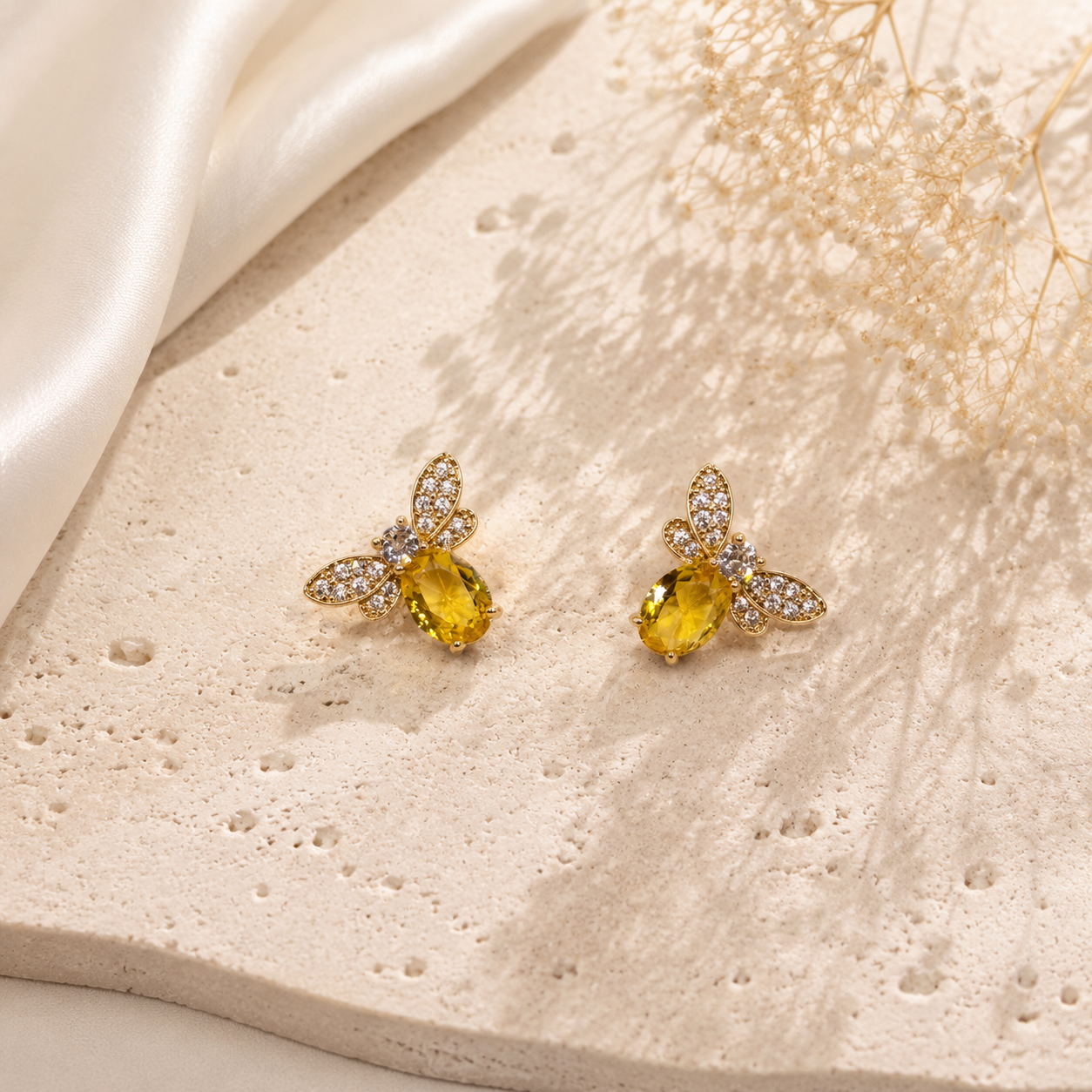 Pair of gold-tone mini bee stud earrings with yellow stone-style bodies and clear crystal-style wings
