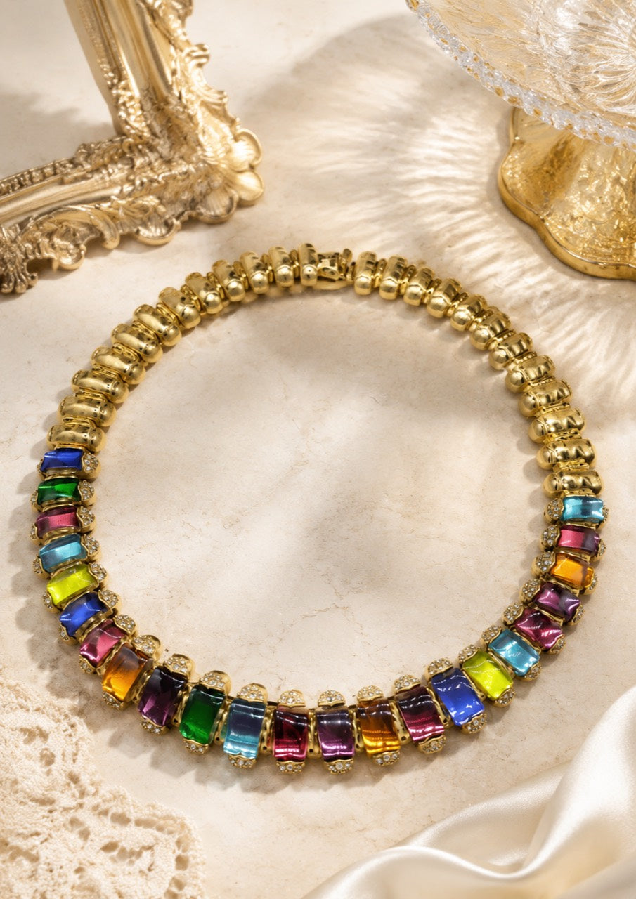 Gold-tone statement necklace with multicolor rectangular crystal-style accents