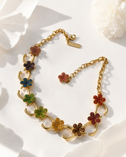 Gold-tone necklace with multicolor floral rhinestone-style accents angled view