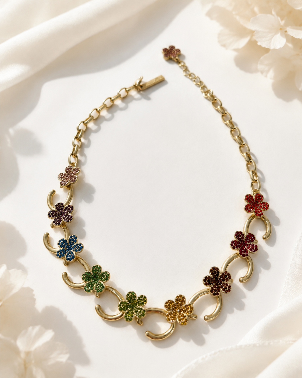 Gold-tone necklace with multicolor floral rhinestone-style accents front view