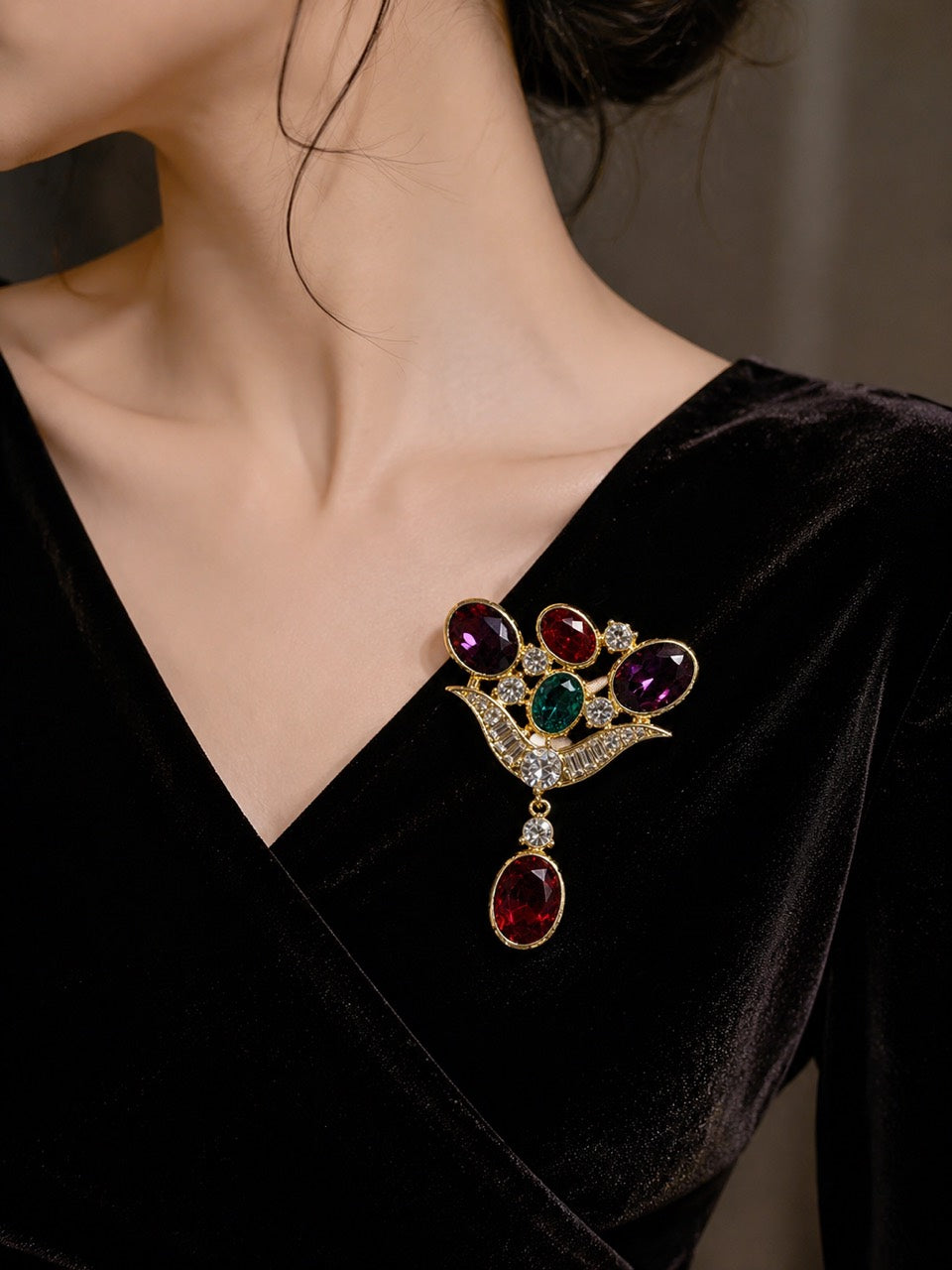Gold-tone multicolor glass drop statement brooch styled on black velvet