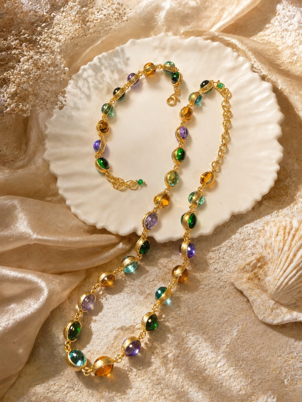 Gold-tone multicolor glass necklace and bracelet set flat lay view