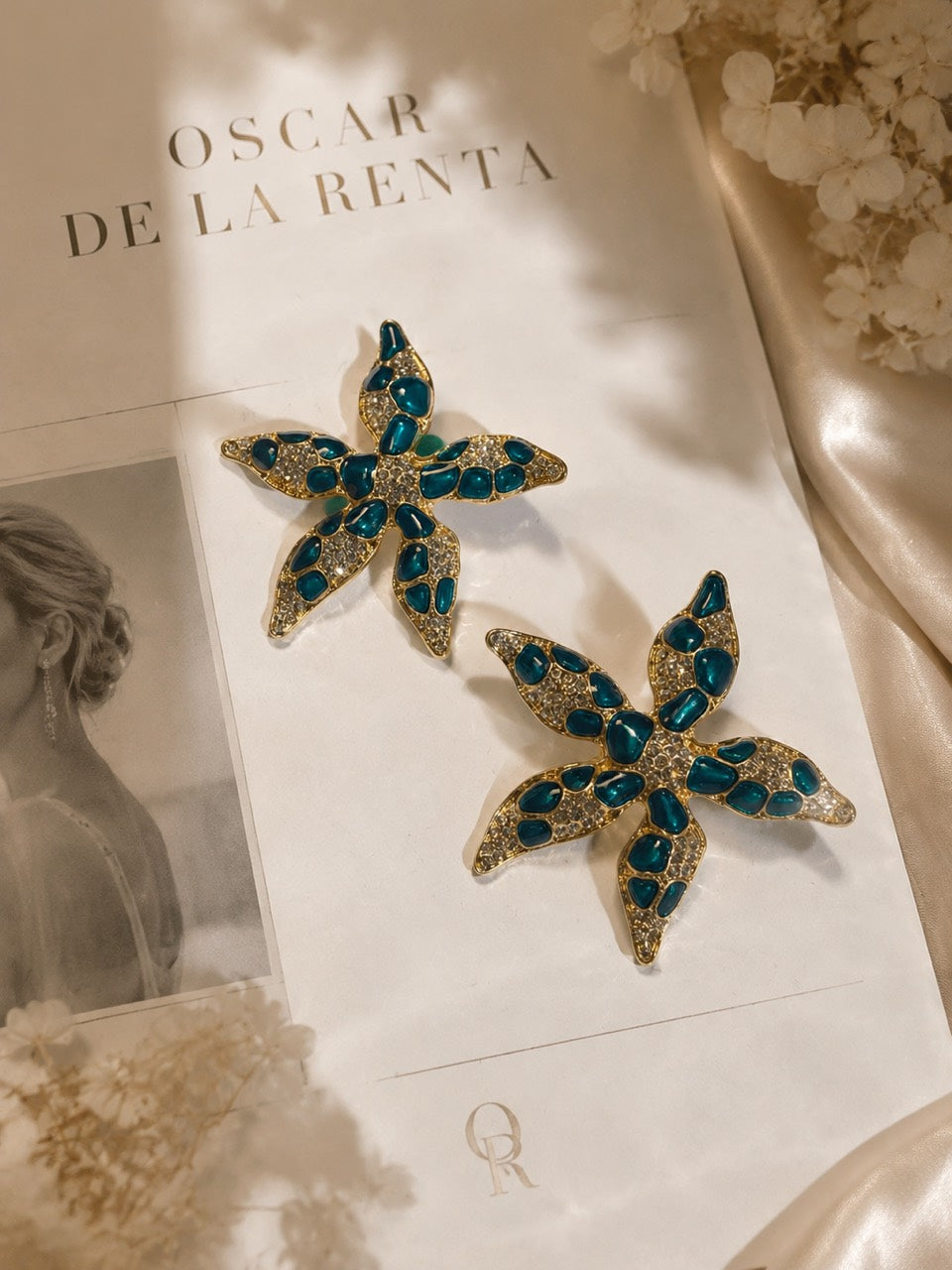 Gold-tone Ocean Teal crystal-style starfish stud earrings pair display