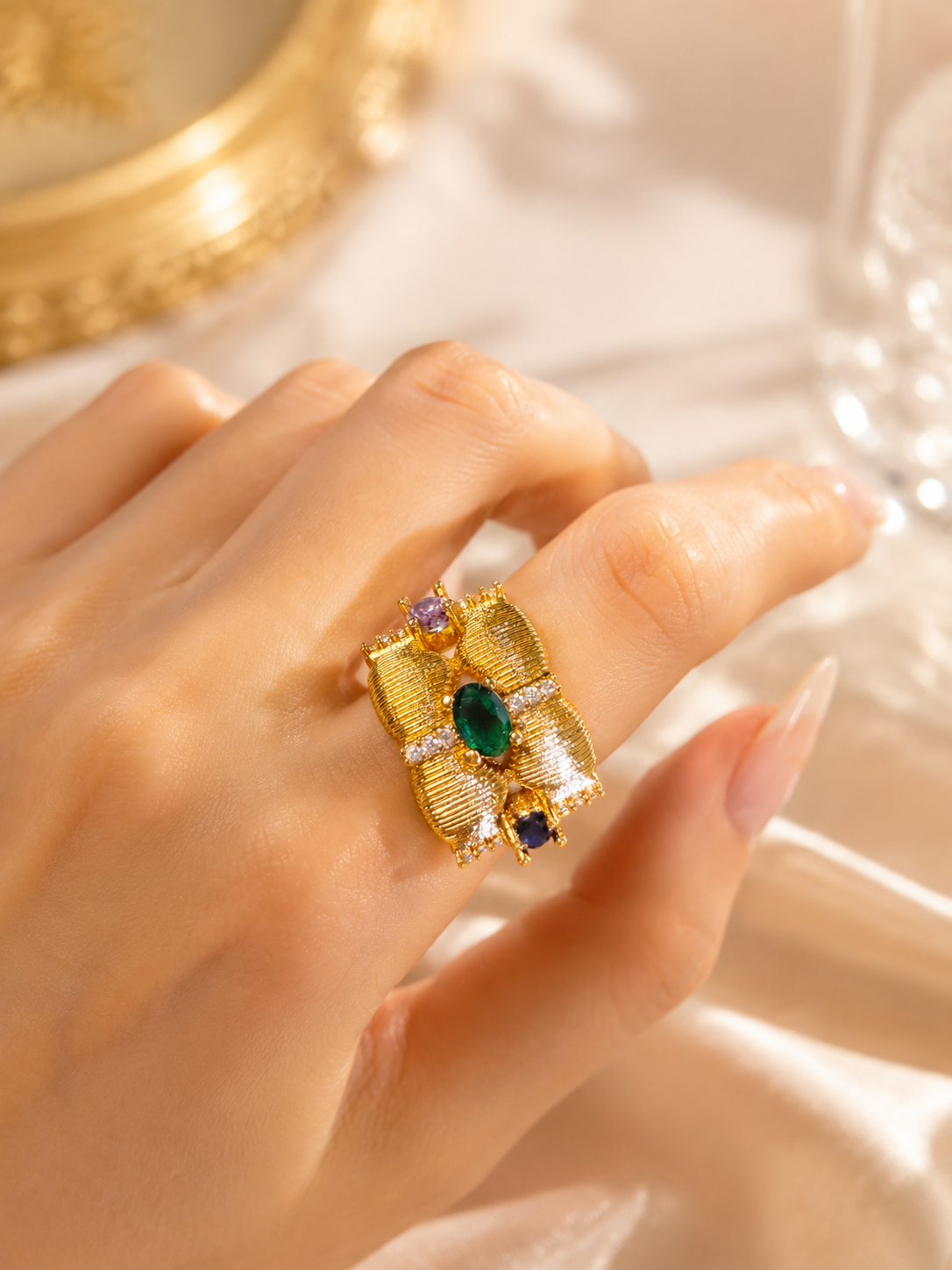 Gold-tone open adjustable crystal-style ring worn on hand