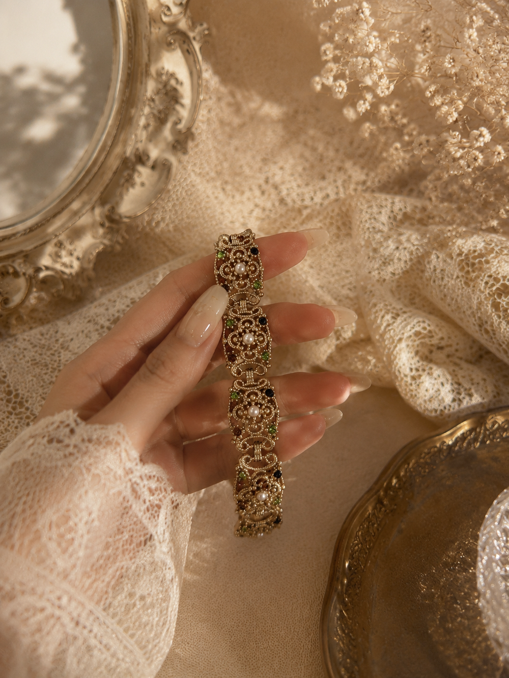 Gold-tone ornate pearl-style link bracelet size 8 held in hand