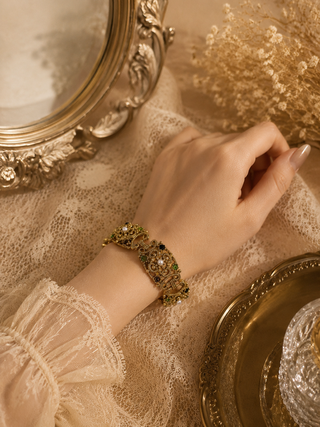 Gold-tone ornate pearl-style link bracelet size 8 worn on wrist