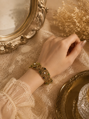 Gold-tone ornate pearl-style link bracelet size 8 worn on wrist