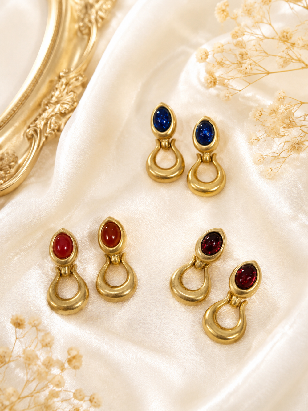 Gold-tone oval stone-style loop stud earrings in red, blue, and pomegranate red