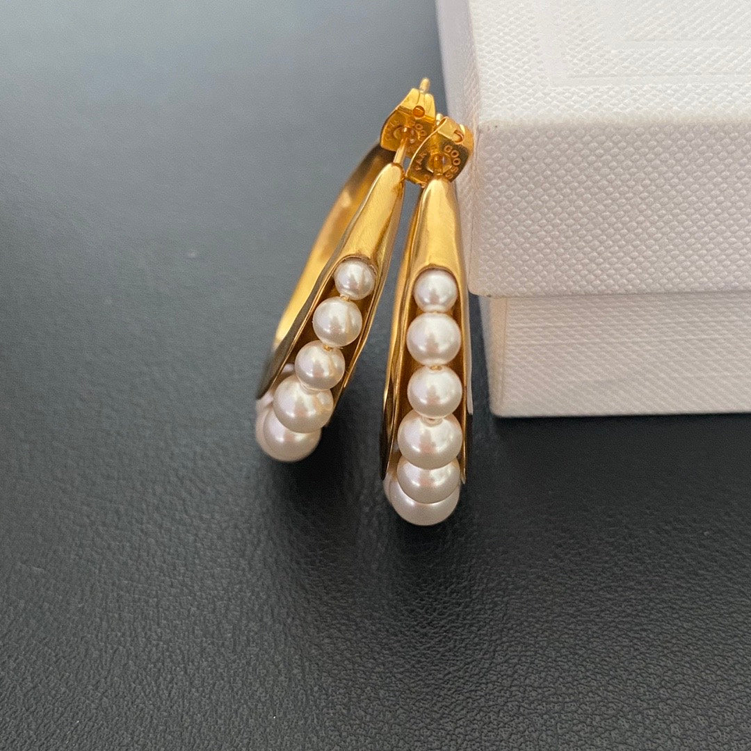 Gold-tone pearl-style crescent hoop stud earrings side view