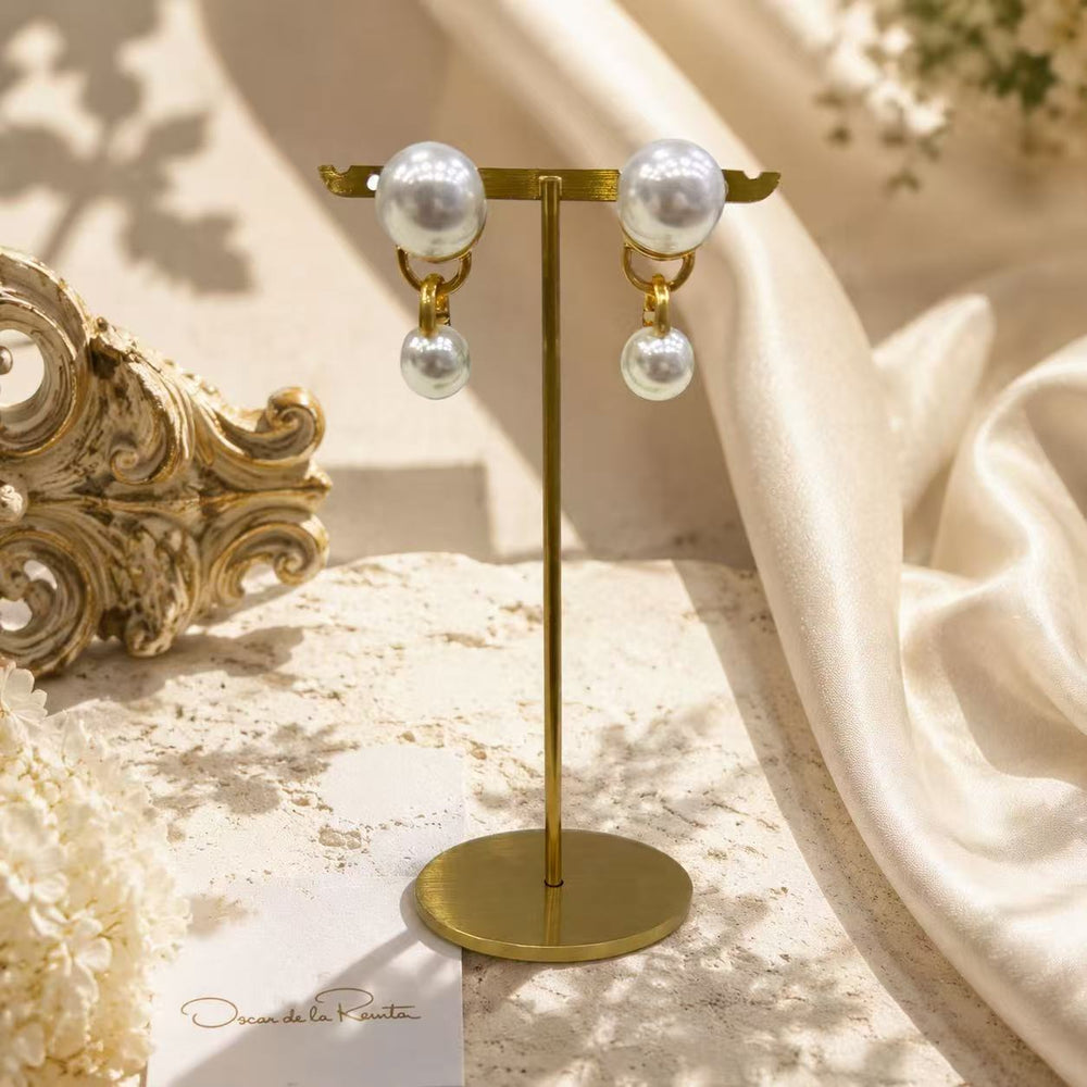 Gold-tone pearl-style double-sphere drop stud earrings display view
