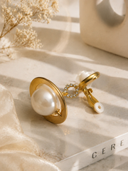 Gold-tone pearl-style orbital drop earrings clip-on back detail