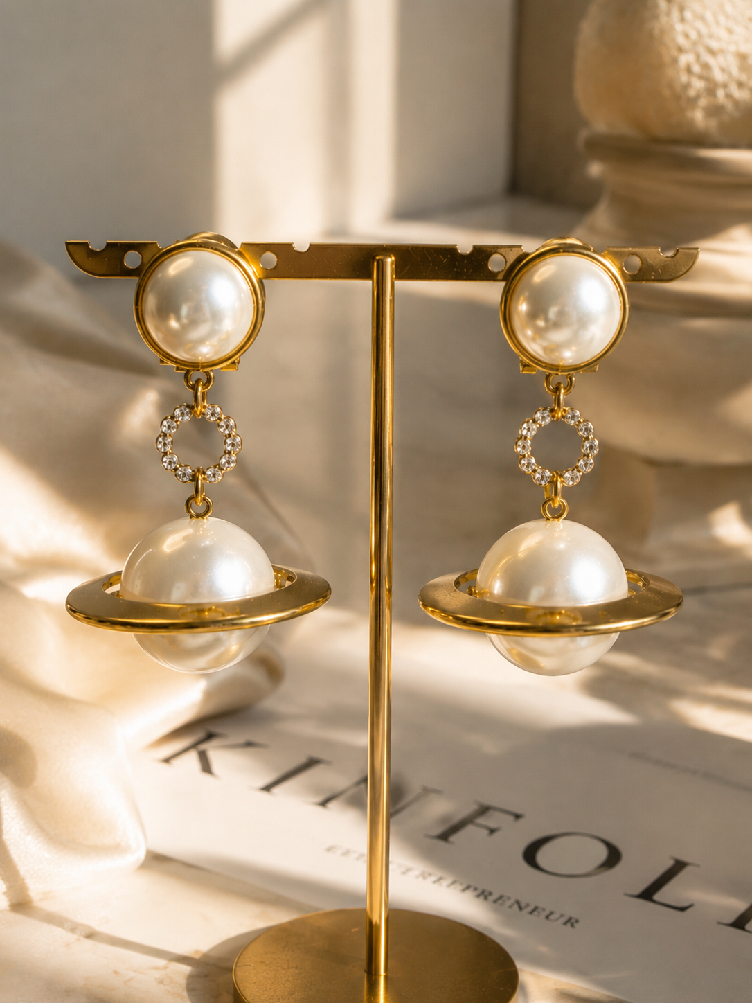 Gold-tone pearl-style orbital drop earrings front view