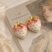 Gold-tone pink-and-cream enamel-style strawberry stud earrings detail