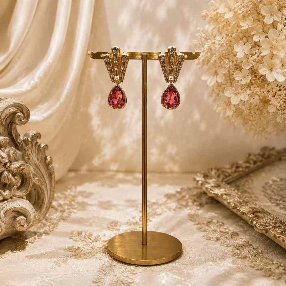 Gold-tone pink teardrop crystal-style stud earrings front view