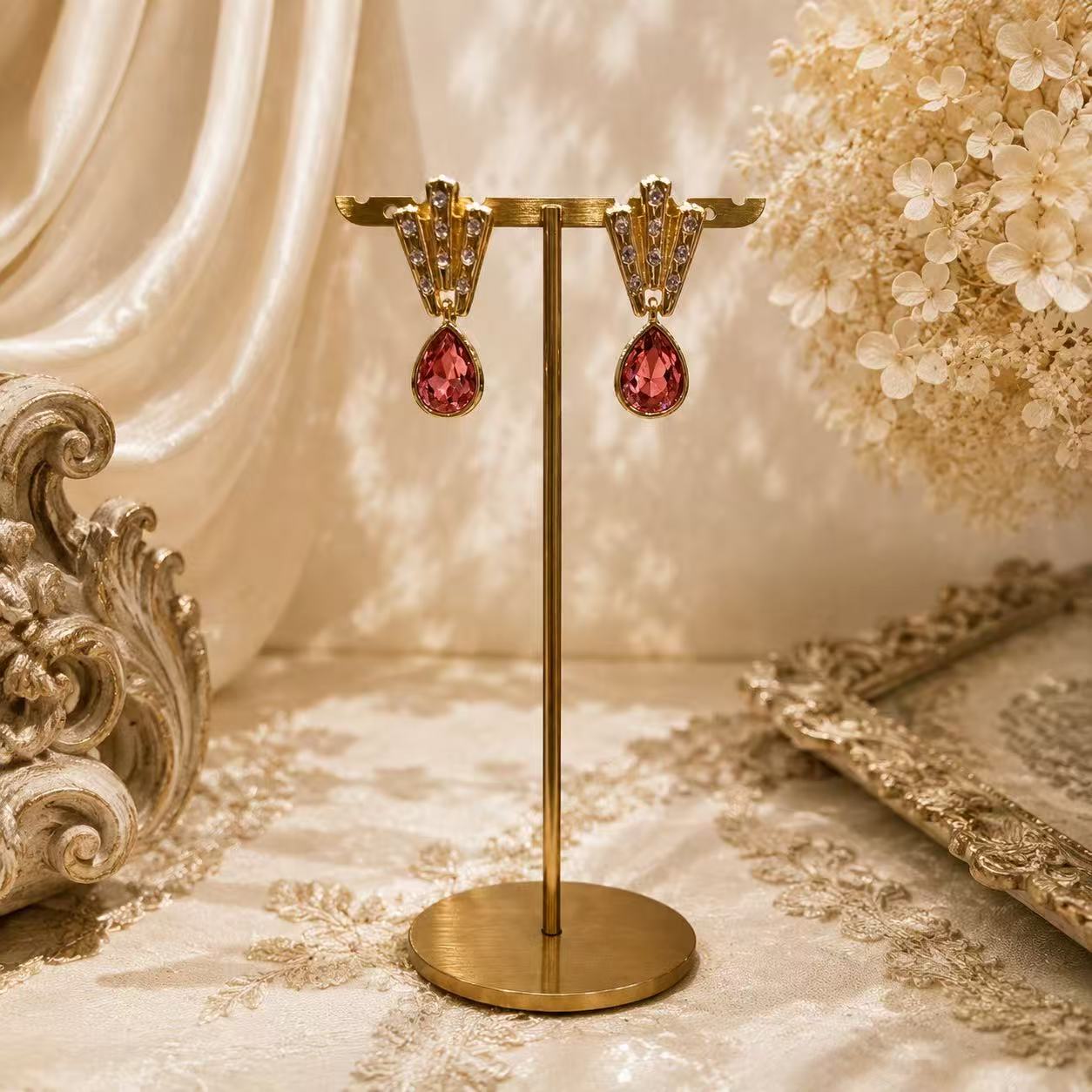 Gold-tone pink teardrop crystal-style-style stud earrings front view