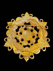 Back view of gold-tone ornate statement brooch with pin closure