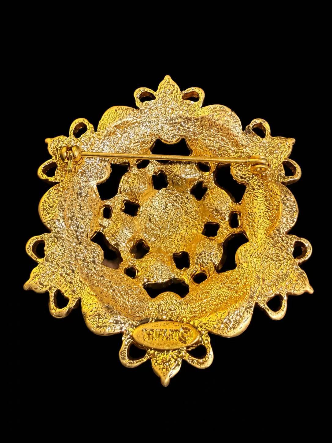 Back view of gold-tone ornate statement brooch with pin closure