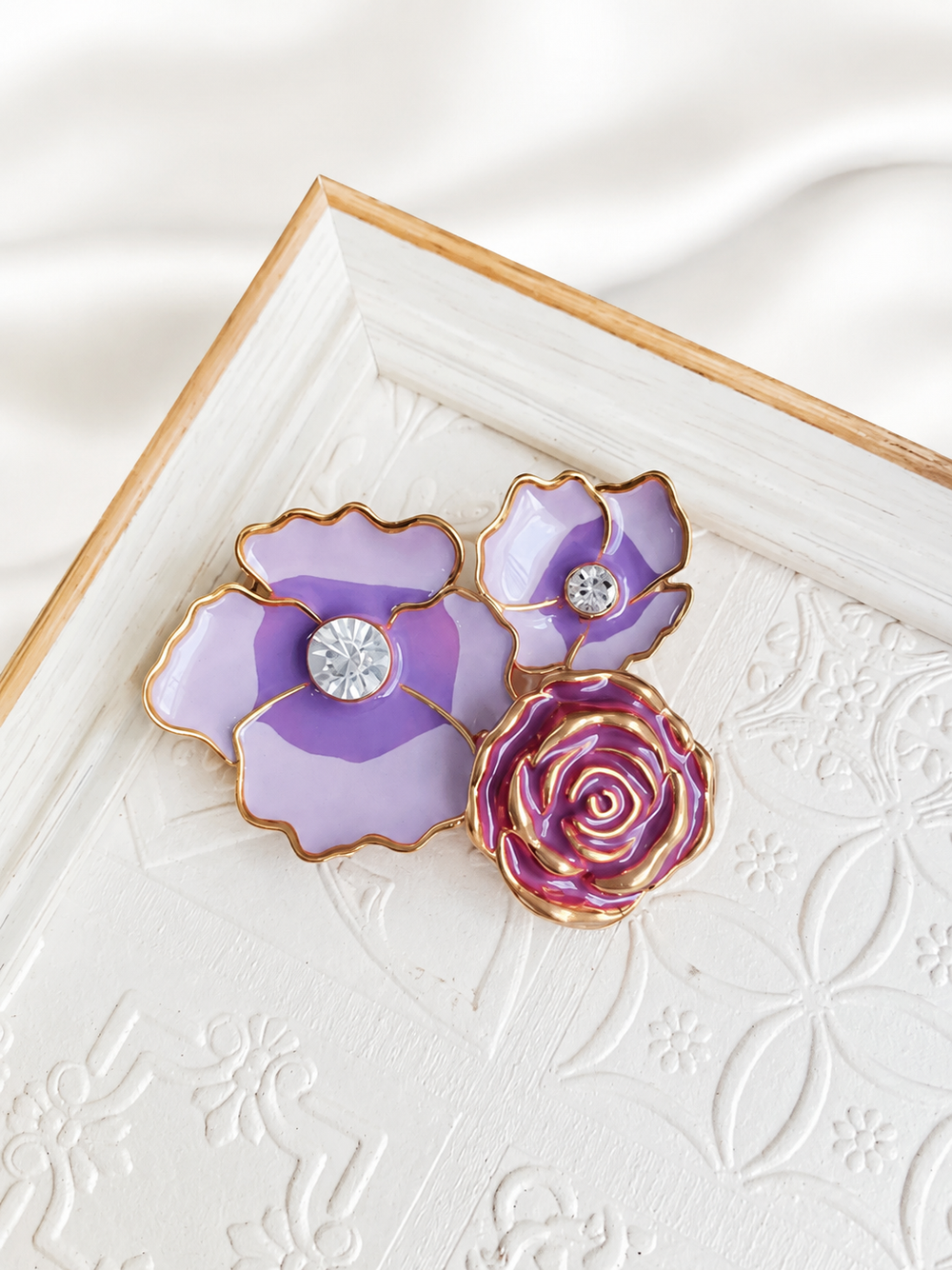 Gold-tone purple enamel-style floral statement brooch with crystal-style accents front view