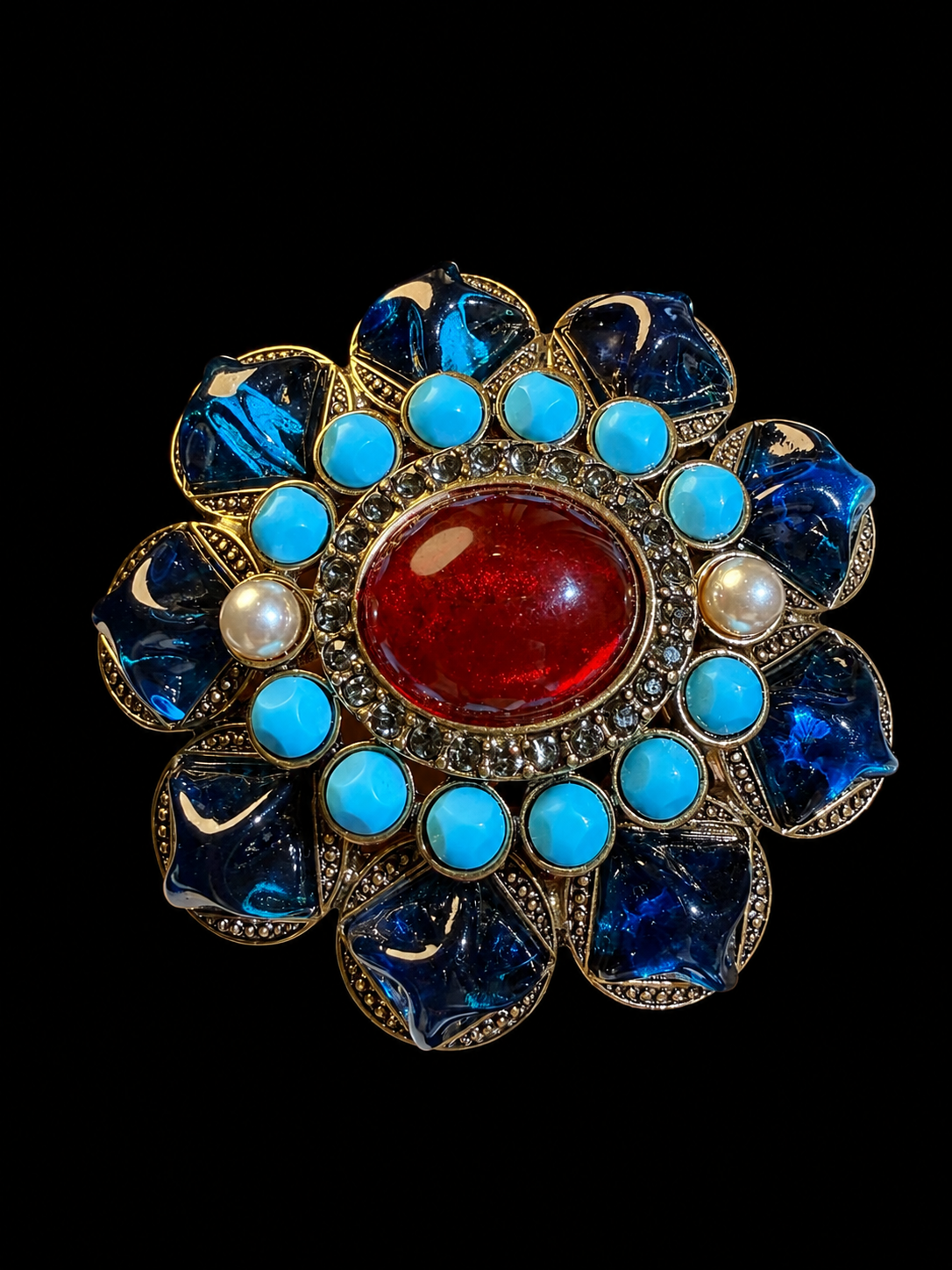 Gold-tone red and blue resin-style floral statement brooch angled front view
