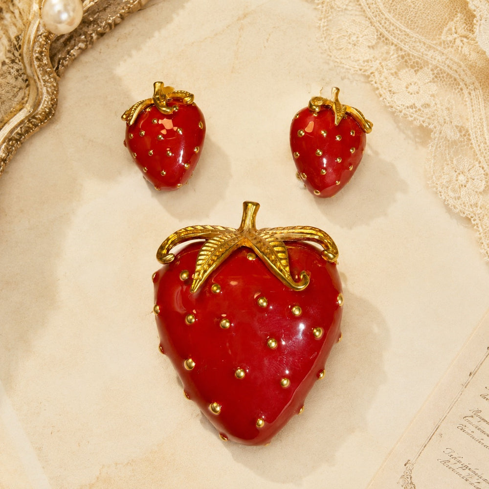 Gold-tone red enamel-style strawberry brooch and clip-on earrings set front view