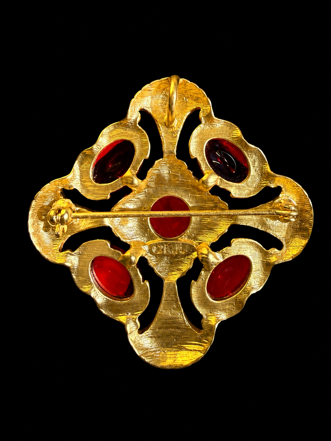 Gold-tone red glass cabochon-style brooch pendant back view with pin closure and pendant loop