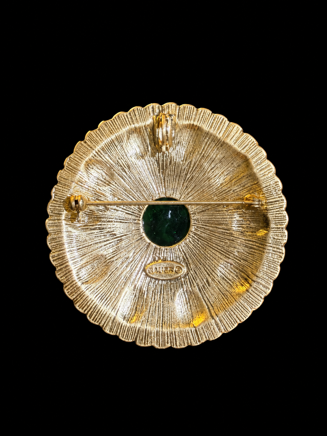 Back view of gold-tone round green cabochon-style brooch pendant with pin and pendant loop