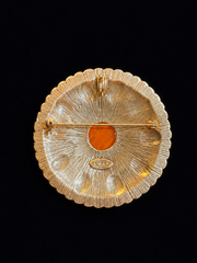 Back view of gold-tone round orange yellow cabochon-style brooch pendant with pin and pendant loop