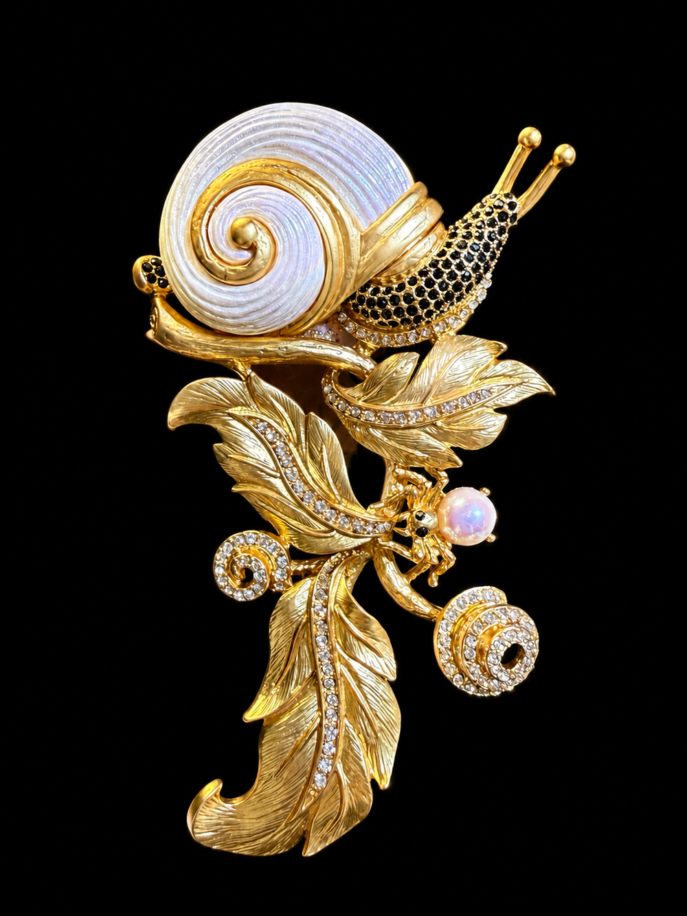 Gold-tone snail and leaf statement brooch front view with crystal-style accents