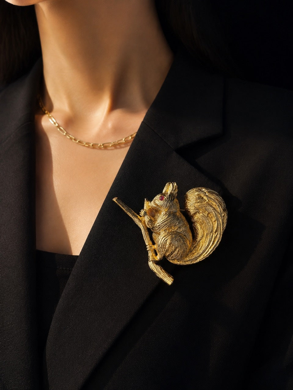 Gold-tone squirrel convertible brooch pendant styled on black blazer