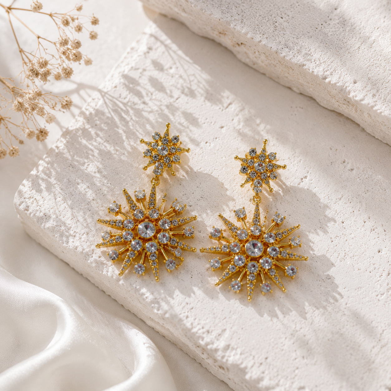 Gold-tone starburst crystal-style-style stud earrings clear color front view