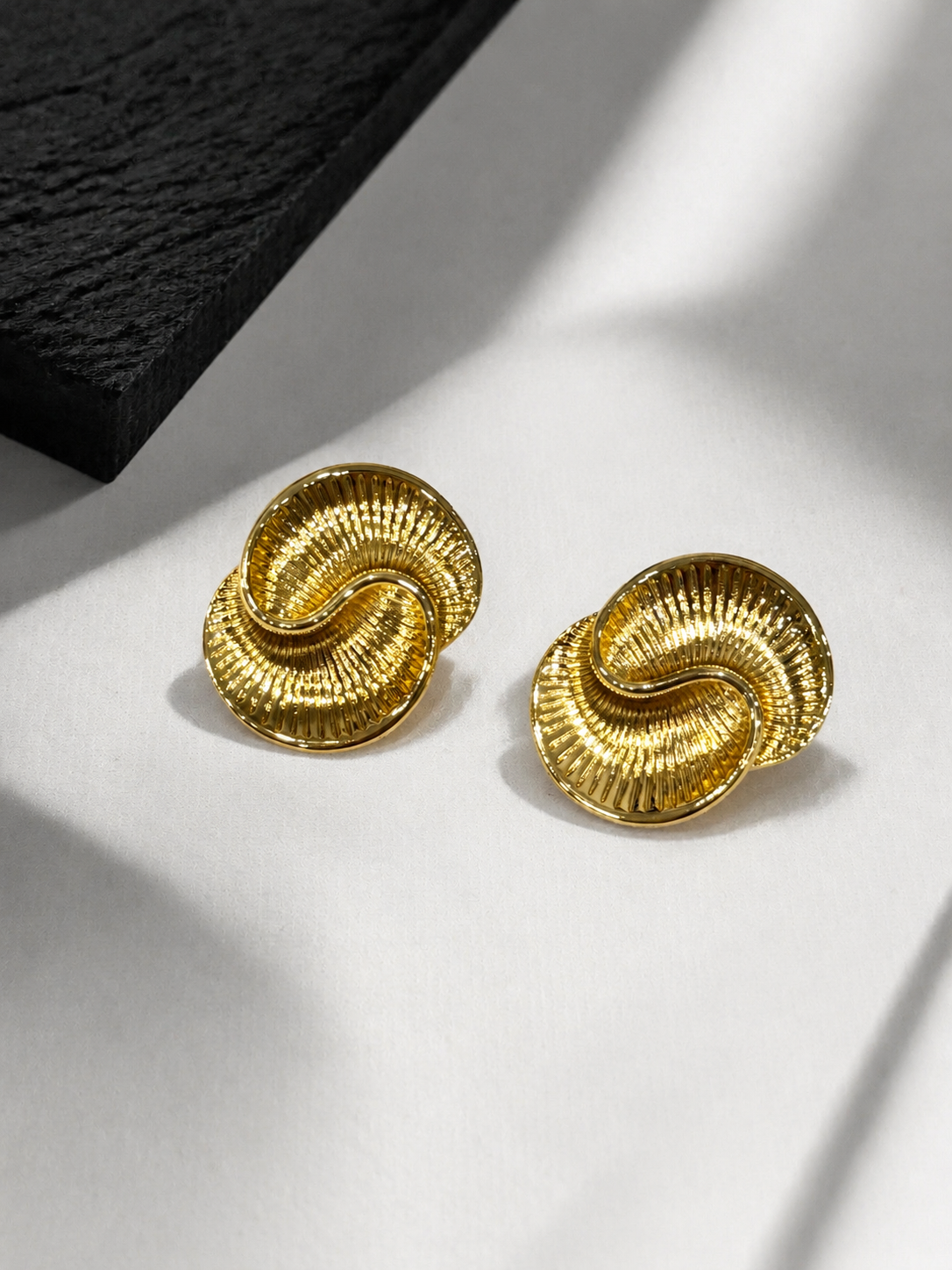 Gold-tone textured statement stud earrings detail view
