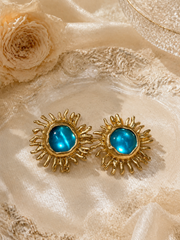 Gold-tone light blue sunflower glass-style stud earrings