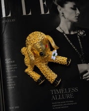 Gold-tone textured lamb statement brooch styled on magazine page