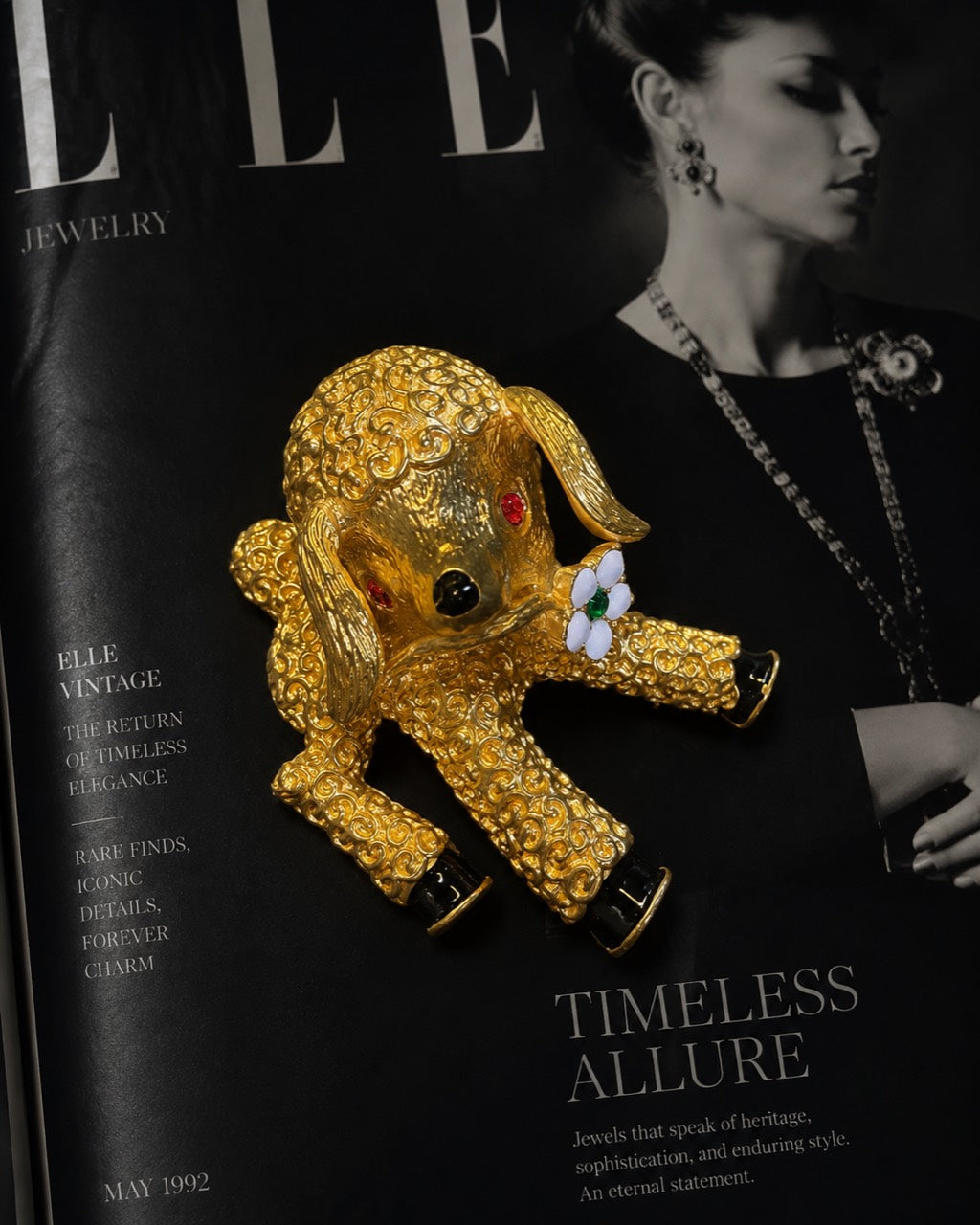Gold-tone textured lamb statement brooch styled on magazine page