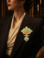 Gold-tone turquoise-style ornate statement brooch styled on black blazer
