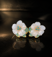 Gold-tone white flower stud earrings with blue crystal-style accents