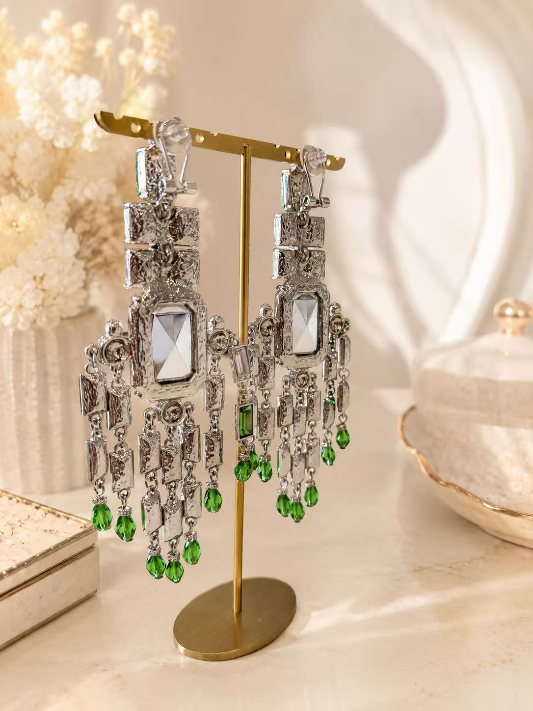 Back view of green and clear crystal-style chandelier clip-on earrings with clip closures