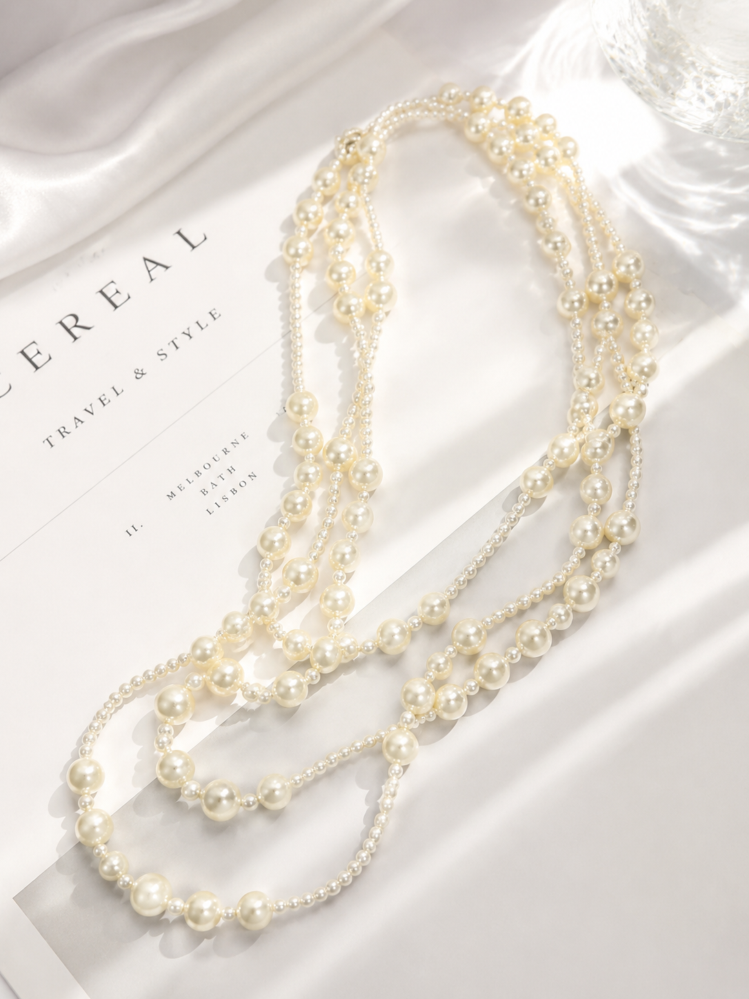 Layered pearl-style statement necklace flat lay detail view