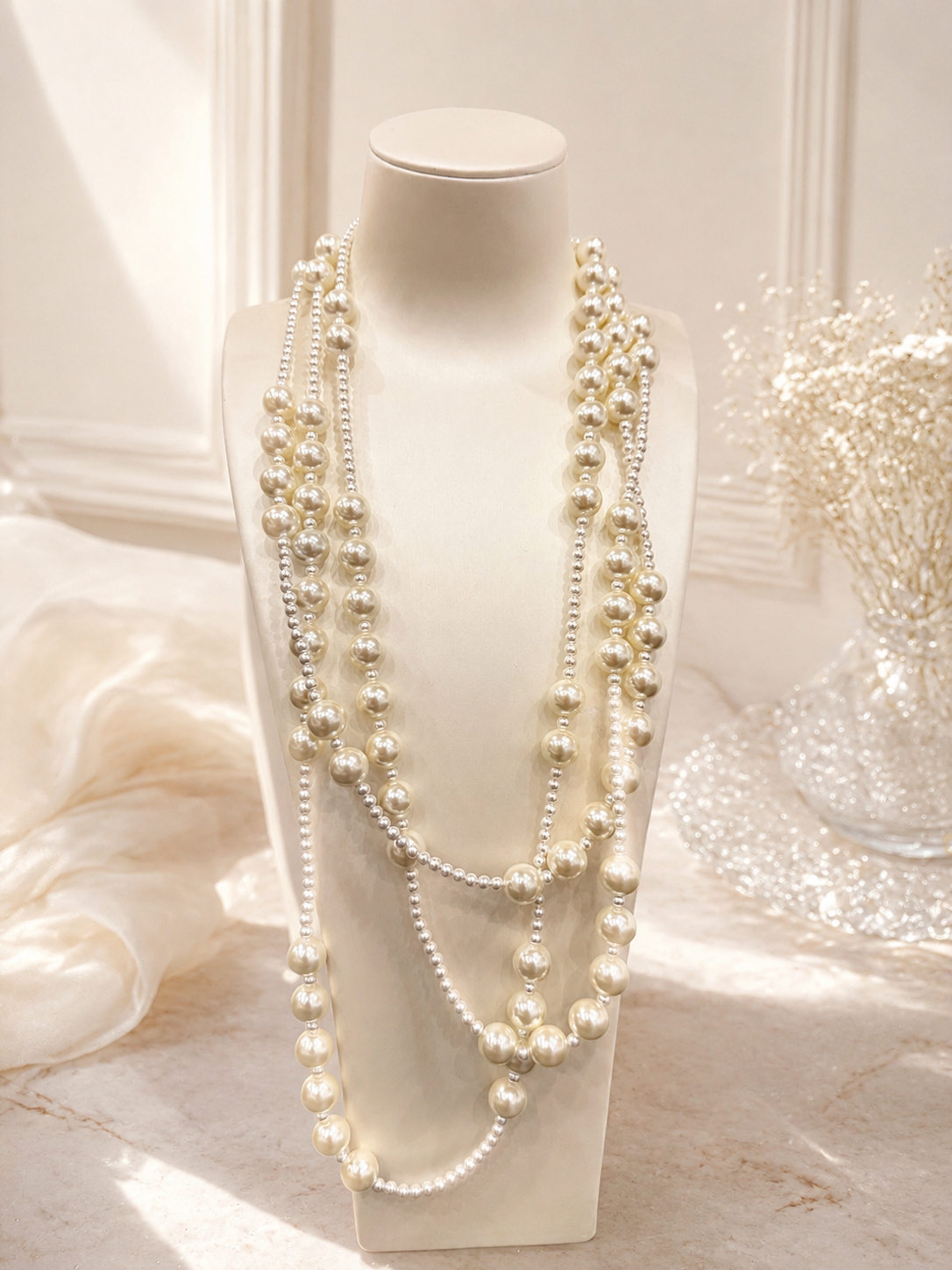 Layered pearl-style statement necklace front display on bust