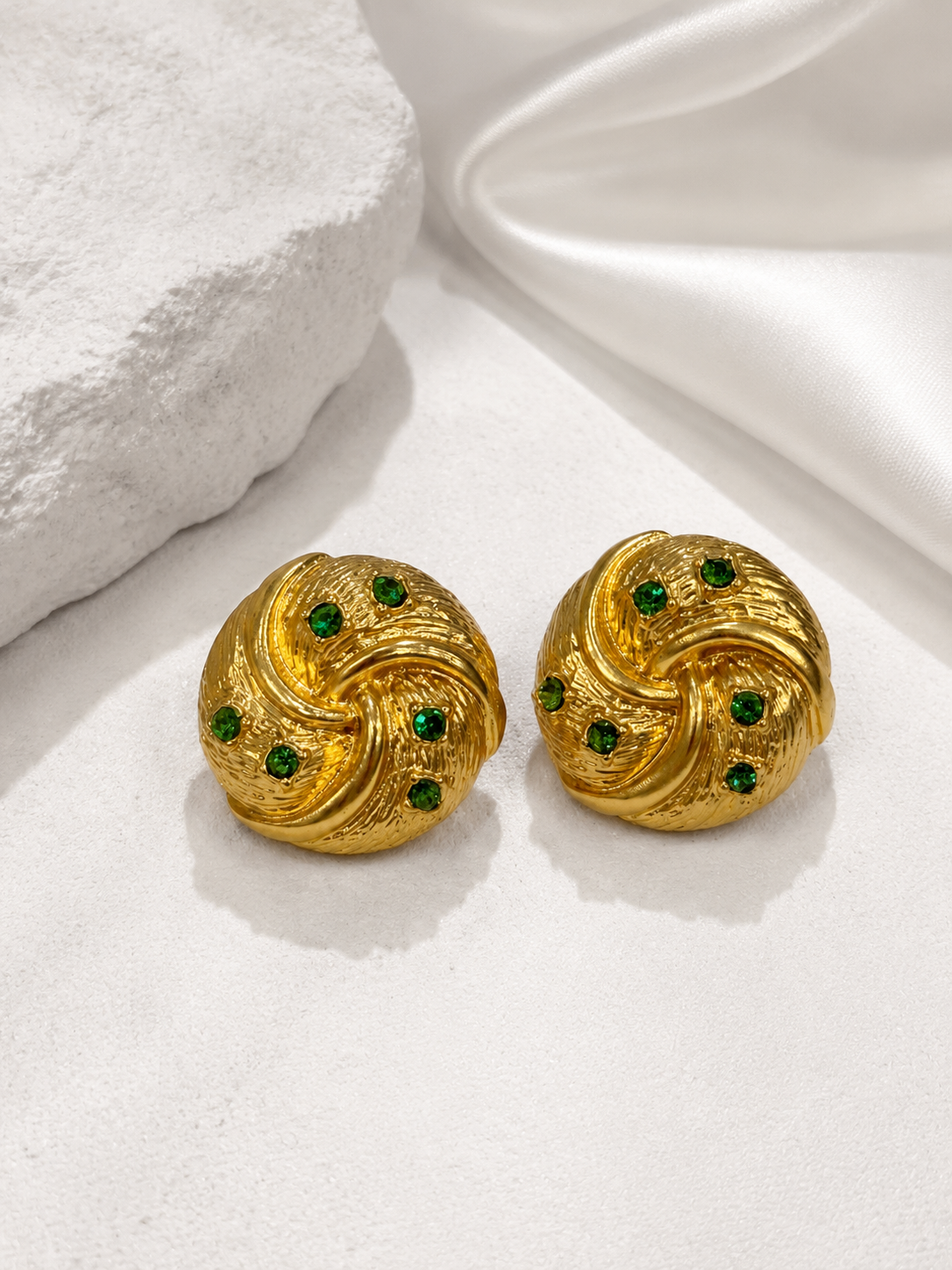 Gold-tone light green crystal-style earrings front view